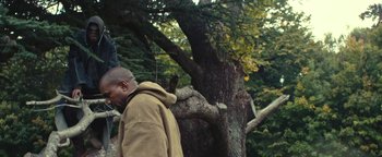 Movie still from “Travis Scott & Kanye West - Piss on your Grave” (2015), directed by Nabil Elderkin – Medium shot, Low angle
