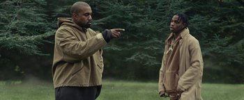 Movie still from “Travis Scott & Kanye West - Piss on your Grave” (2015), directed by Nabil Elderkin – Medium shot, Over the shoulder angle