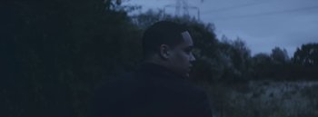 Movie still from “Dels - Burning Beaches” (2014), directed by Us – Medium shot, Low angle