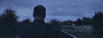 Movie still from “Dels - Burning Beaches” (2014), directed by Us – Medium shot, Low angle