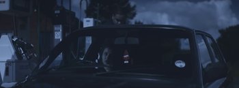 Movie still from “Dels - Burning Beaches” (2014), directed by Us – Medium shot, Over the shoulder angle