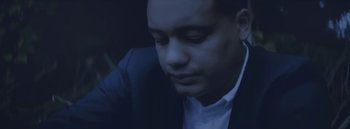 Movie still from “Dels - Burning Beaches” (2014), directed by Us – Close Up shot, Low angle