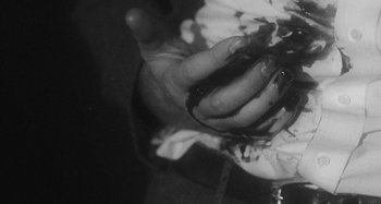 Movie still from “Timber Timbre - Curtains?!” (2014), directed by Tyler T. Williams – Extreme Close Up shot, Overhead angle