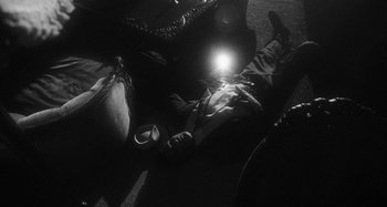 Movie still from “Timber Timbre - Curtains?!” (2014), directed by Tyler T. Williams – Wide shot, Overhead angle
