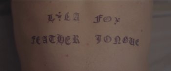 Movie still from “Lyla Foy - Feather Tongue” (2014), directed by Oscar Hudson – Extreme Close Up shot, Overhead angle