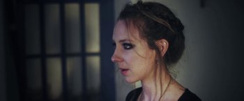 Movie still from “Lyla Foy - Feather Tongue” (2014), directed by Oscar Hudson – Close Up shot, Low angle