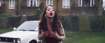Movie still from “Lyla Foy - Feather Tongue” (2014), directed by Oscar Hudson – Medium shot, Low angle
