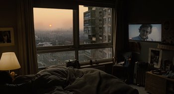 Movie still from “Children of Men” (2006), directed by Alfonso Cuarón – A view of a city from a bed room window; Wide shot, High angle