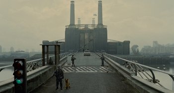 Movie still from “Children of Men” (2006), directed by Alfonso Cuarón – Two people and a dog on a bridge; Extreme Wide shot, Low angle