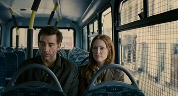 Movie still from “Children of Men” (2006), directed by Alfonso Cuarón – A man and a woman sitting on a bus; Medium shot, Over the shoulder angle