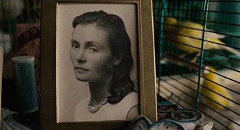 Movie still from “Children of Men” (2006), directed by Alfonso Cuarón – An old photo of a woman in a frame; Extreme Close Up shot, High angle