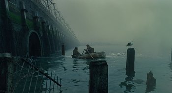 Movie still from “Children of Men” (2006), directed by Alfonso Cuarón – Two people in a boat in a body of water; Extreme Wide shot, High angle