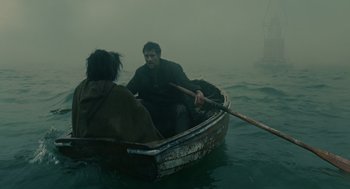 Movie still from “Children of Men” (2006), directed by Alfonso Cuarón – A man and a woman are in a boat in the water; Wide shot, High angle