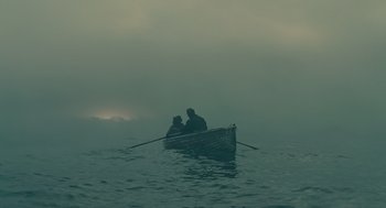 Movie still from “Children of Men” (2006), directed by Alfonso Cuarón – Two people in a boat in the middle of the ocean; Extreme Wide shot, High angle