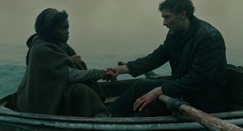 Movie still from “Children of Men” (2006), directed by Alfonso Cuarón – Two people sitting in a boat on the water; Medium shot, Over the shoulder angle