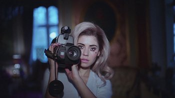 Movie still from “Marina And The Diamonds - Primadonna” (2012), directed by Casper Balslev – Close Up shot, Overhead angle