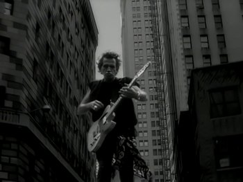 Movie still from “The Rolling Stones - Love Is Strong” (1994), directed by David Fincher – Medium shot, Low angle