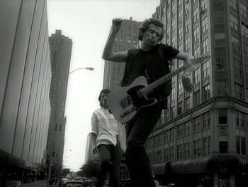 Movie still from “The Rolling Stones - Love Is Strong” (1994), directed by David Fincher – Medium shot, Low angle