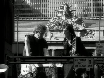 Movie still from “The Rolling Stones - Love Is Strong” (1994), directed by David Fincher – Medium shot, Low angle