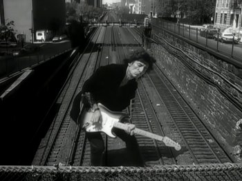 Movie still from “The Rolling Stones - Love Is Strong” (1994), directed by David Fincher – Medium shot, Low angle