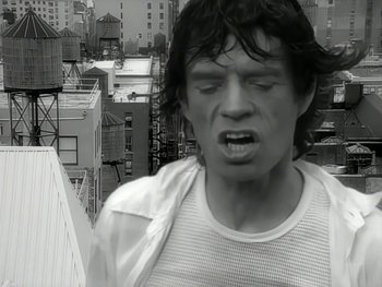Movie still from “The Rolling Stones - Love Is Strong” (1994), directed by David Fincher – Close Up shot, Low angle