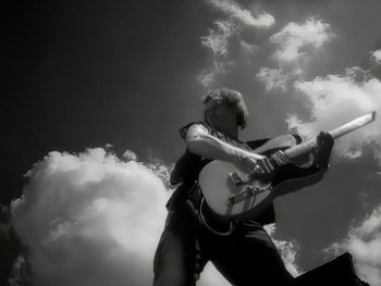 Movie still from “The Rolling Stones - Love Is Strong” (1994), directed by David Fincher – Wide shot, Low angle