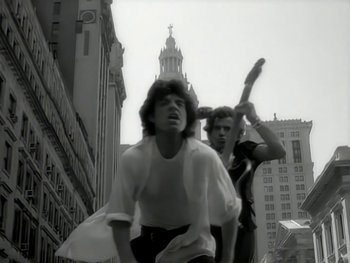 Movie still from “The Rolling Stones - Love Is Strong” (1994), directed by David Fincher – Medium shot, Low angle