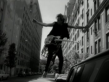 Movie still from “The Rolling Stones - Love Is Strong” (1994), directed by David Fincher – Wide shot, Low angle