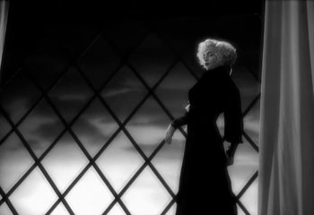 Movie still from “Madonna - Vogue” (1990), directed by David Fincher – Medium shot, Low angle