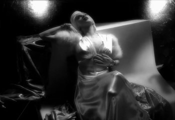 Movie still from “Madonna - Vogue” (1990), directed by David Fincher – Medium shot, Low angle