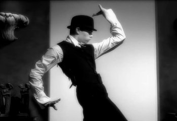 Movie still from “Madonna - Vogue” (1990), directed by David Fincher – Medium shot, Low angle