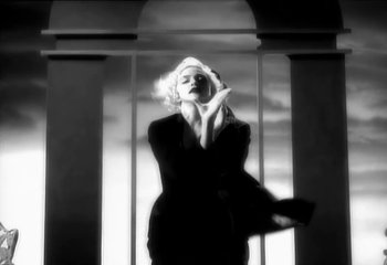 Movie still from “Madonna - Vogue” (1990), directed by David Fincher – Medium shot, Low angle