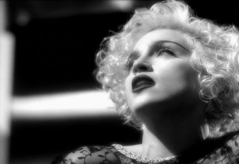 Movie still from “Madonna - Vogue” (1990), directed by David Fincher – Extreme Close Up shot, Low angle