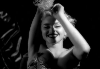 Movie still from “Madonna - Vogue” (1990), directed by David Fincher – Close Up shot, Low angle
