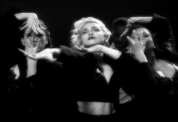 Movie still from “Madonna - Vogue” (1990), directed by David Fincher – Medium shot, Low angle