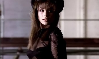 Movie still from “Paula Abdul - Cold Hearted” (1989), directed by David Fincher – Close Up shot, Over the shoulder angle