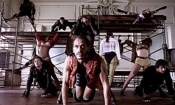 Movie still from “Paula Abdul - Cold Hearted” (1989), directed by David Fincher – Wide shot, Low angle