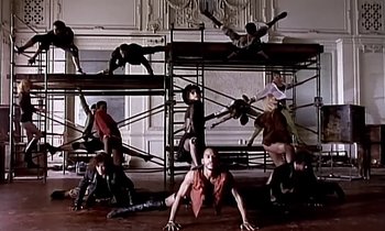 Movie still from “Paula Abdul - Cold Hearted” (1989), directed by David Fincher – Wide shot, Low angle