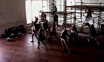 Movie still from “Paula Abdul - Cold Hearted” (1989), directed by David Fincher – Wide shot, High angle