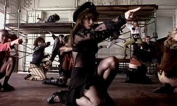 Movie still from “Paula Abdul - Cold Hearted” (1989), directed by David Fincher – Medium shot, Low angle