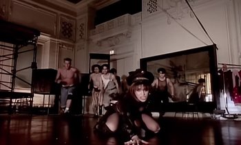 Movie still from “Paula Abdul - Cold Hearted” (1989), directed by David Fincher – Wide shot, Low angle