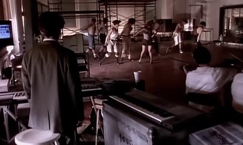 Movie still from “Paula Abdul - Cold Hearted” (1989), directed by David Fincher – Medium shot, High angle