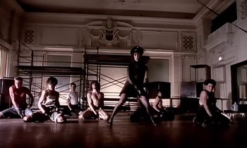 Movie still from “Paula Abdul - Cold Hearted” (1989), directed by David Fincher – Wide shot, Low angle