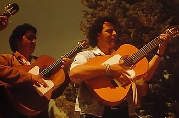 Movie still from “Gipsy Kings - Bamboléo” (1987), directed by David Fincher – Medium shot, Low angle