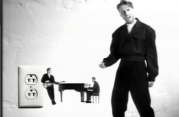 Movie still from “Johnny Hates Jazz - Shattered Dreams” (1987), directed by David Fincher – Medium shot, Low angle