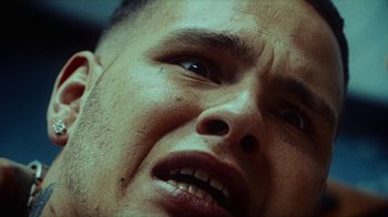 Movie still from “slowthai - Yum” (2023), directed by Owls – Extreme Close Up shot, Overhead angle