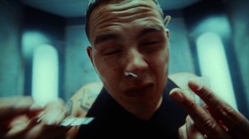 Movie still from “slowthai - Yum” (2023), directed by Owls – Extreme Close Up shot, Overhead angle