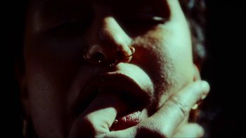 Movie still from “slowthai - Yum” (2023), directed by Owls – Extreme Close Up shot, Overhead angle