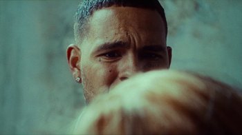 Movie still from “slowthai - Yum” (2023), directed by Owls – Extreme Close Up shot, Over the shoulder angle
