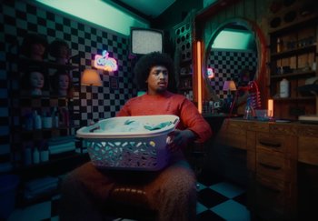 Movie still from “ONHA - KODAK” (2024), directed by Nitram – Medium shot, Low angle